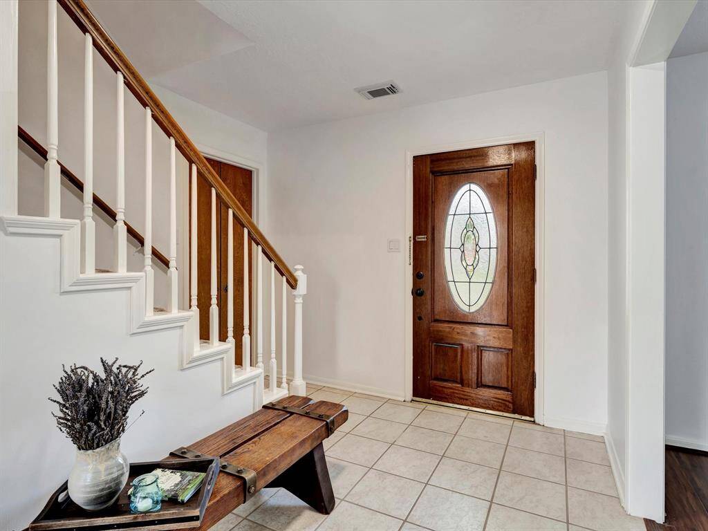 Gracious entryway with leaded glass door.