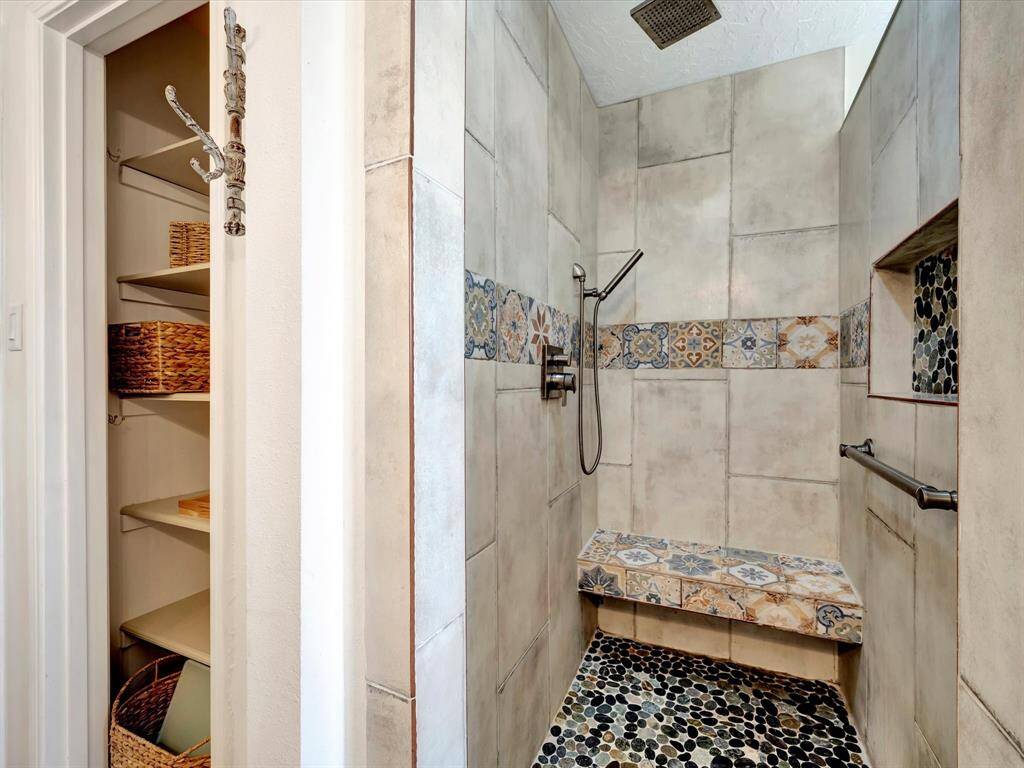Primary shower with rain shower head and spray wand.