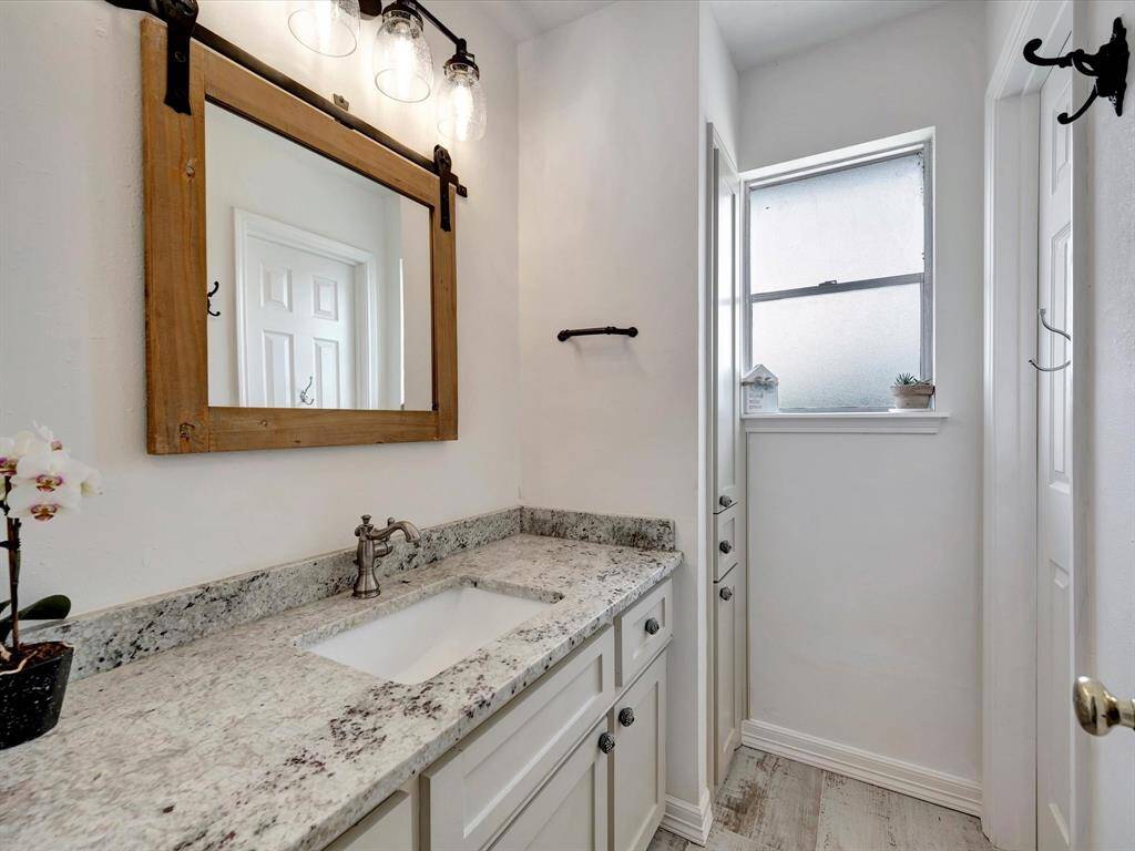 Updated hall bathroom with granite and contemporary fixtures.
