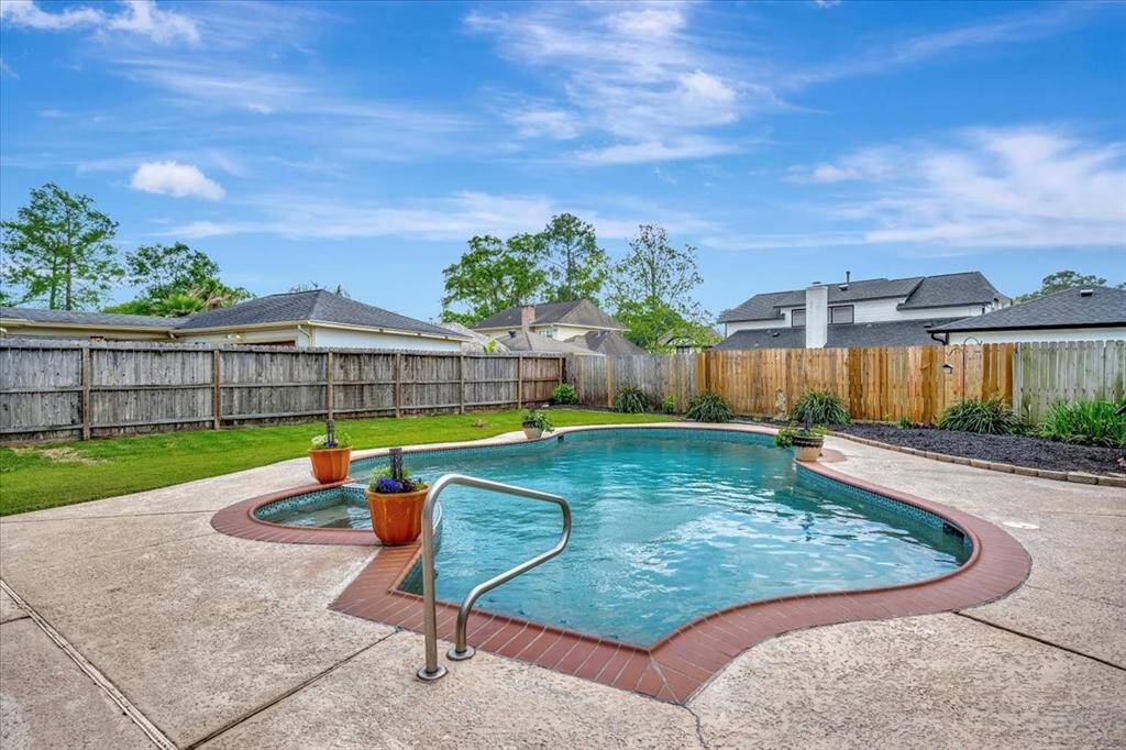 Pool, gardens and large grassy area. This home has them all!