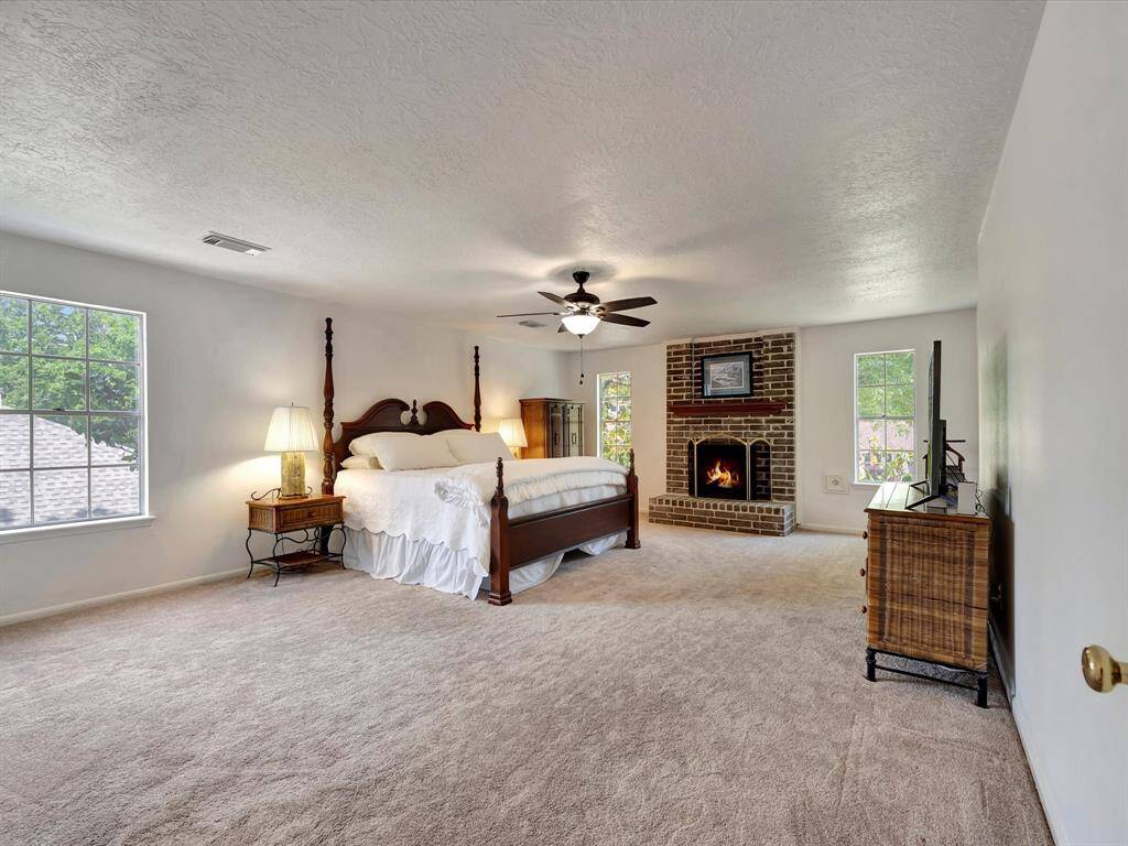 Luxuriously spacious primary suite with gas log fireplace.