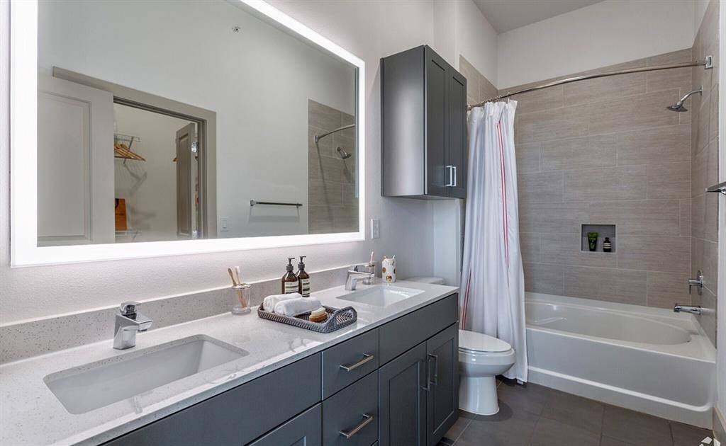 To show finishes. This plan has a stand up shower with a bench. Single sink in vanity. Linen storage.