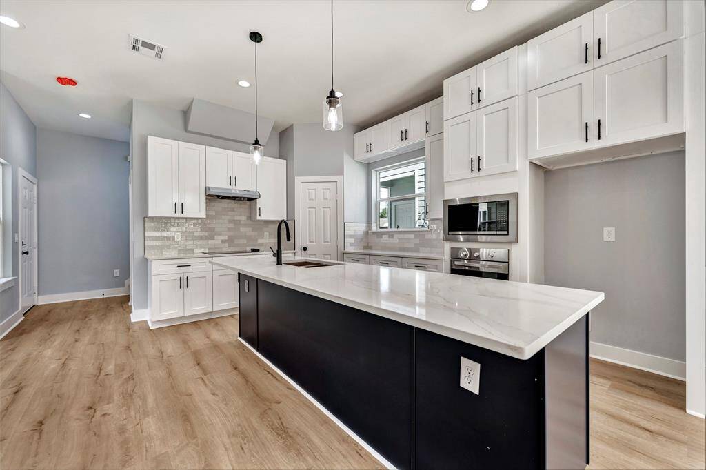 Your culinary adventures await in this spacious kitchen, blending style and functionality for the ultimate cooking experience