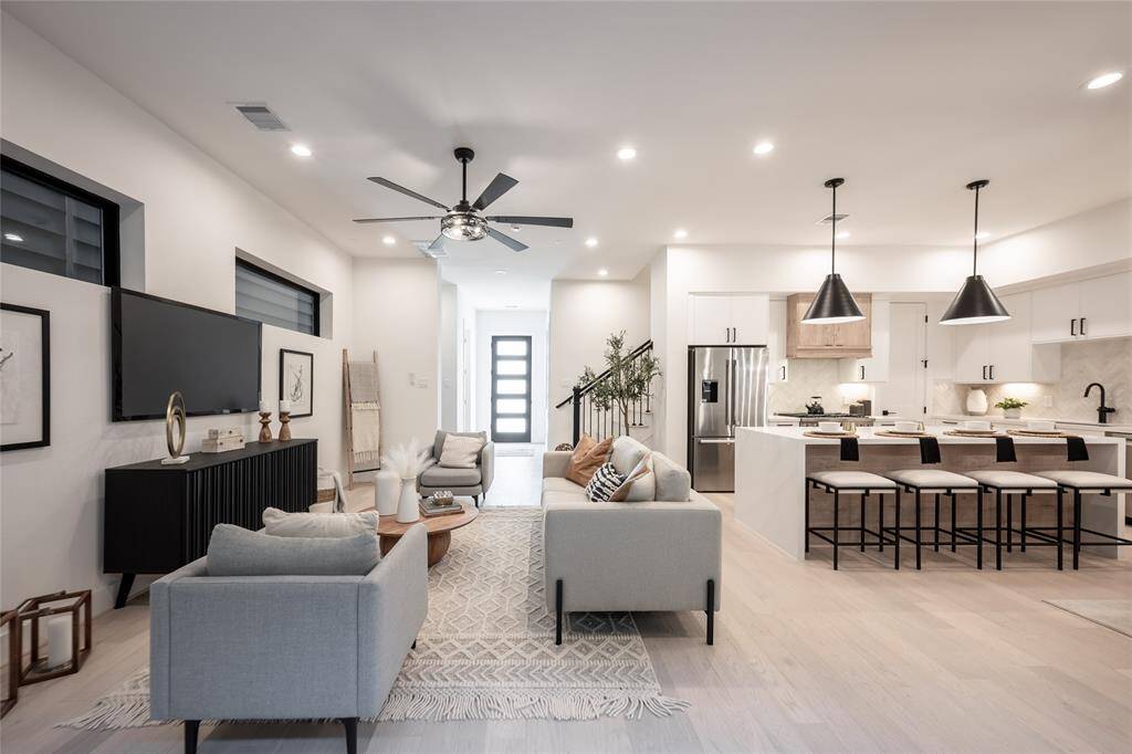 The seamless transition from the kitchen to the dining and living spaces makes for an effortless entertaining experience.