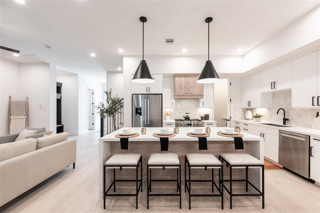 The perfect marriage of beauty and function, this space features waterfall-edge countertops and custom millwork.
