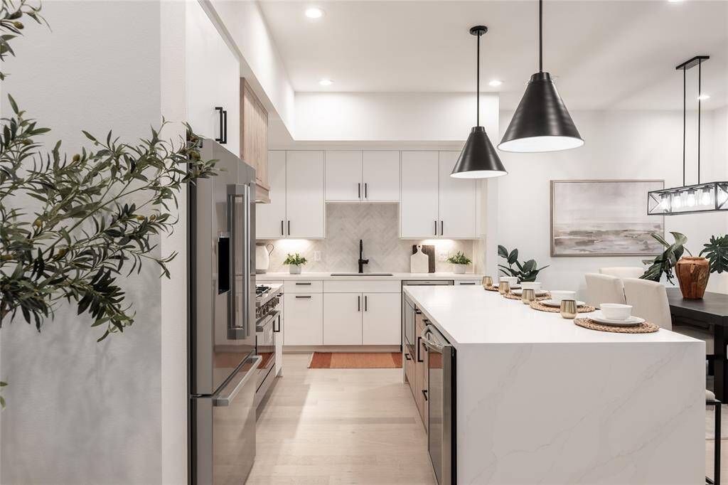 Statement pendant lighting and sleek finishes add a touch of contemporary elegance to this culinary masterpiece.
