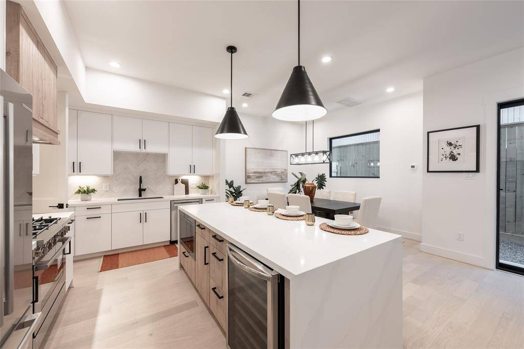 Expansive countertops and a large island provide both visual impact and practical prep space.