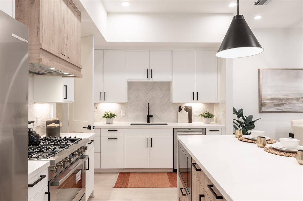 A perfectly framed perspective showcases the kitchen’s sleek symmetry, where custom cabinetry and refined finishes enhance both form and function.