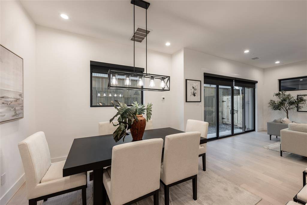 Indoor and outdoor living converge as oversized sliding glass doors blur the lines between home and nature.