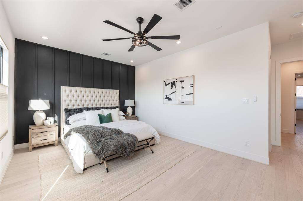 A sanctuary of comfort and sophistication, this expansive primary suite is designed for ultimate relaxation with soaring ceilings and abundant natural light.