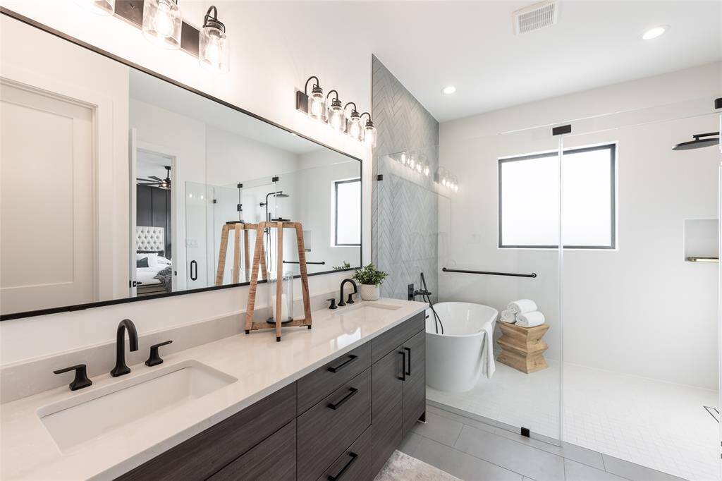 Large-format tiles and subtle textures create a serene retreat designed for relaxation and rejuvenation.