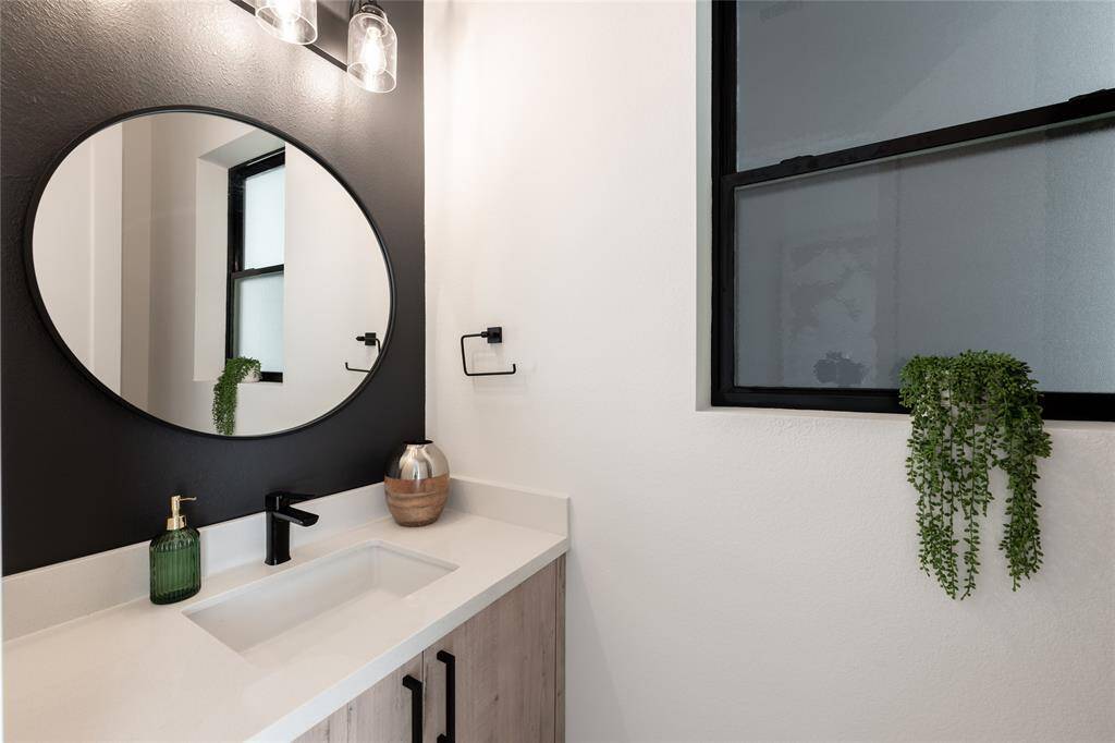 A jewel-box of design, this powder bath showcases high-end finishes and a sleek vanity, embodying modern elegance.