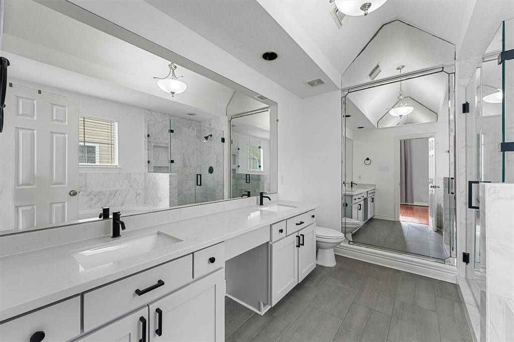 primary bathroom has been updated with Carrara marble tiles, quartz countertops