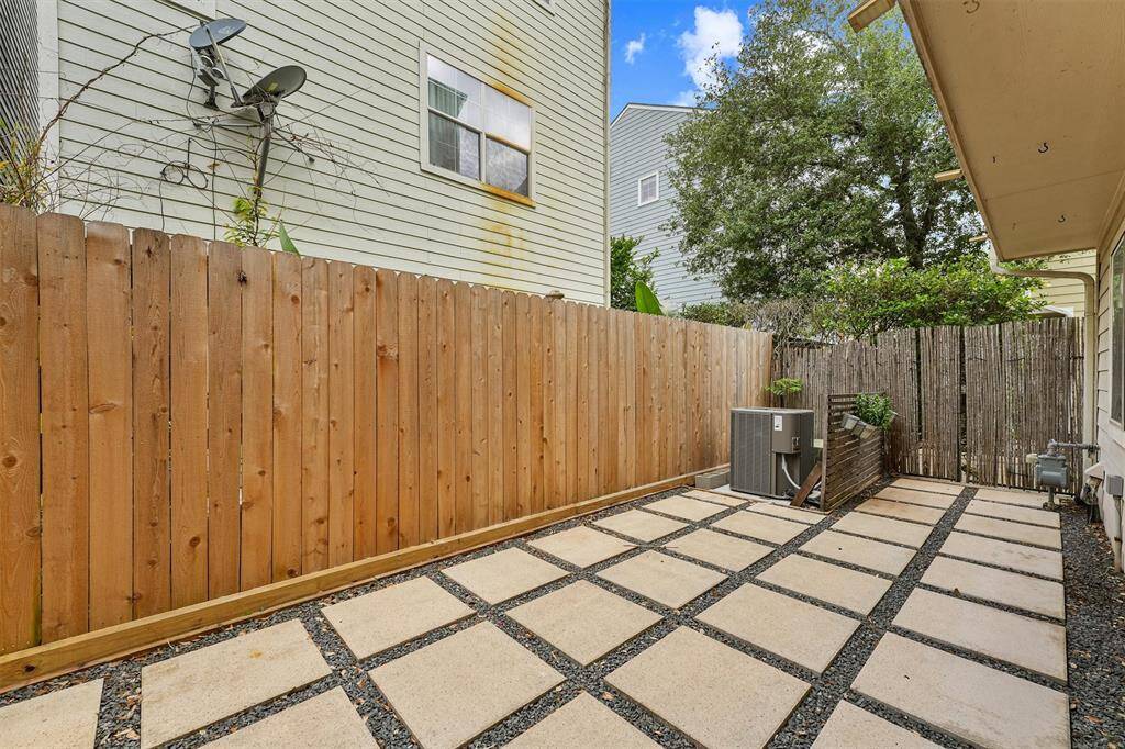the fenced-in backyard features freshly installed pavers that create a clean, low-maintenance outdoor space—perfect for entertaining, relaxing, or al fresco dining. The brand-new fence adds privacy and charm, offering a secure and stylish backdrop for your backyard retreat.