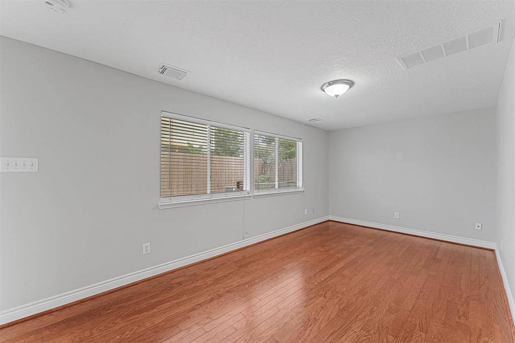 flex room that connects to the garage and leads to the paved patio area