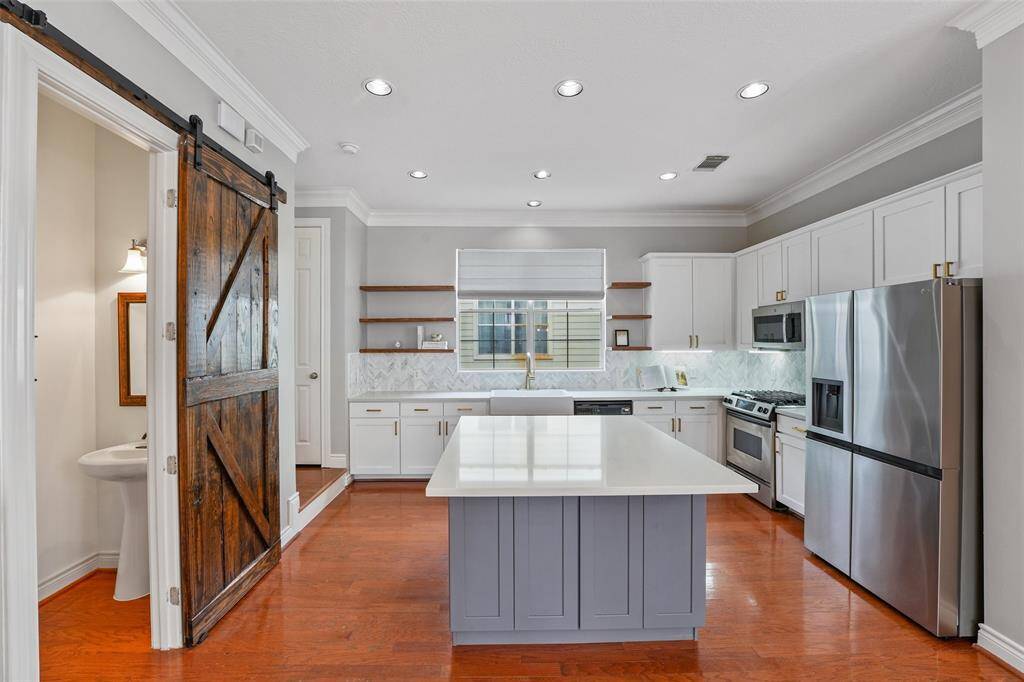 kitchen has been thoughtfully updated with open cabinetry and new countertops