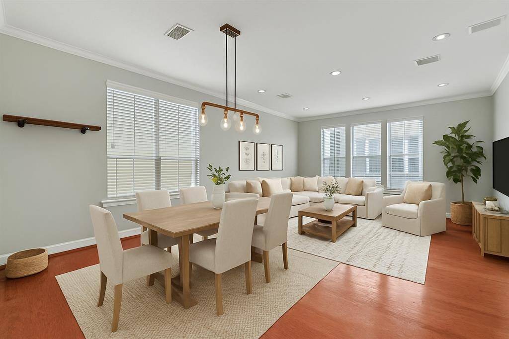 The open-concept layout seamlessly blends the dining and living areas, while the corner unit’s abundance of natural light creates a warm, inviting atmosphere and beautifully brightens the entire space