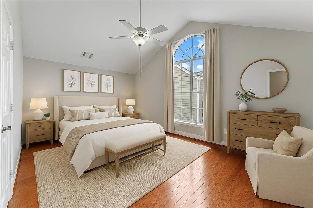 primary bedroom features a vaulted ceiling and two spacious walk-in closets