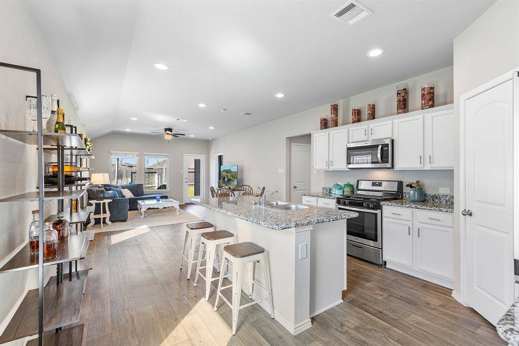 Open-concept living at its best—cook, dine, and relax all in one beautifully connected space!