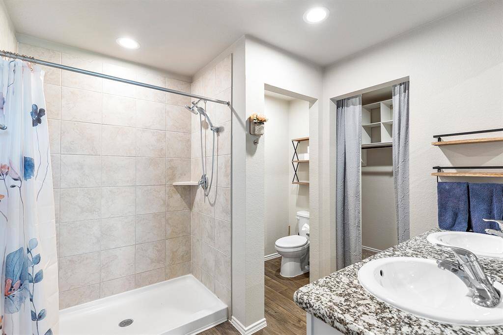 Start your day in this spa-inspired primary bath with a walk-in shower, double sinks, and roomy closets.