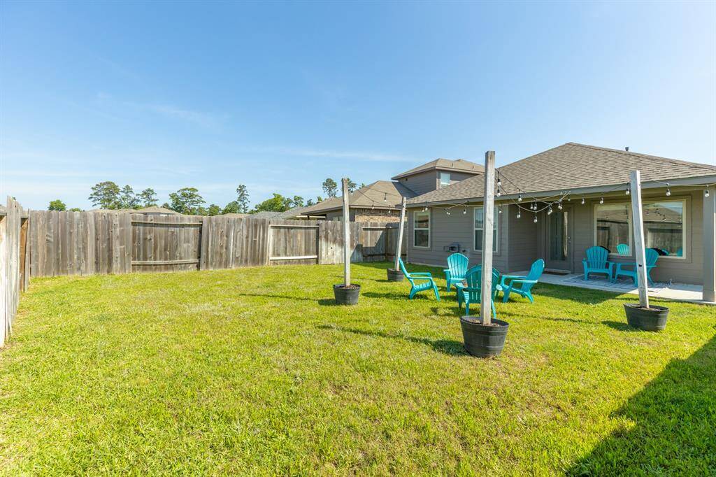 A generous backyard offers plenty of room for pets, play, and future personalization.