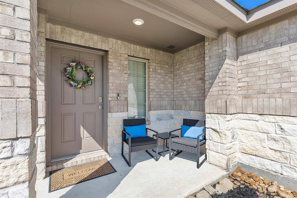 A charming front porch with seating—perfect for morning coffee or evening hellos.
