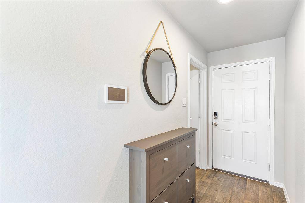 Welcome home! This cozy and stylish entryway, complete with shoe storage, sets the tone with charm and warmth from the moment you step inside.