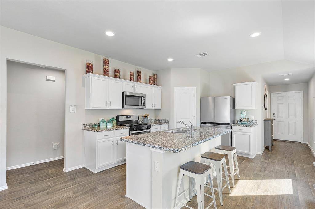 Light, bright, and packed with storage! This kitchen is ready for everything from morning coffee to weekend gatherings. Fit to match any modern decor.