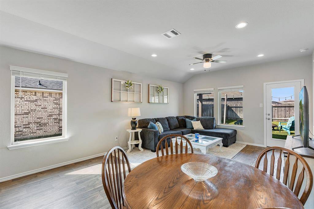 Natural light floods in, highlighting the warm tones and inviting layout of this cheerful space.