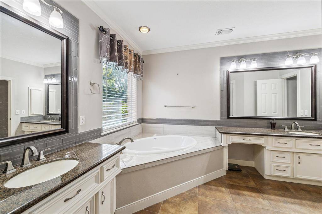 Primary ensuite bath with large soaking tub and double vanities