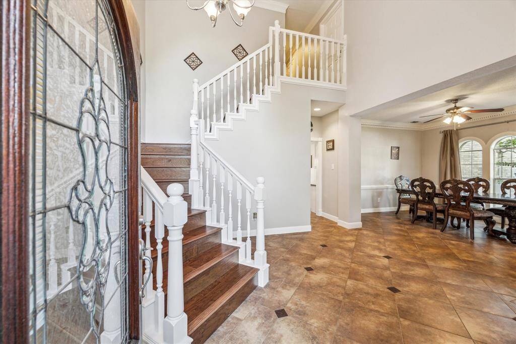 Grand foyer with winding staircase and open to formals