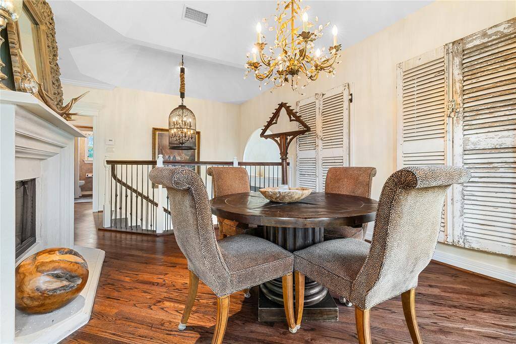 PERCHED ABOVE THE ENTRY, THIS CHARMING BREAKFAST AREA FEATURING A CRYSTAL CHANDELIER AND WARM HARDWOOD FLOORS.