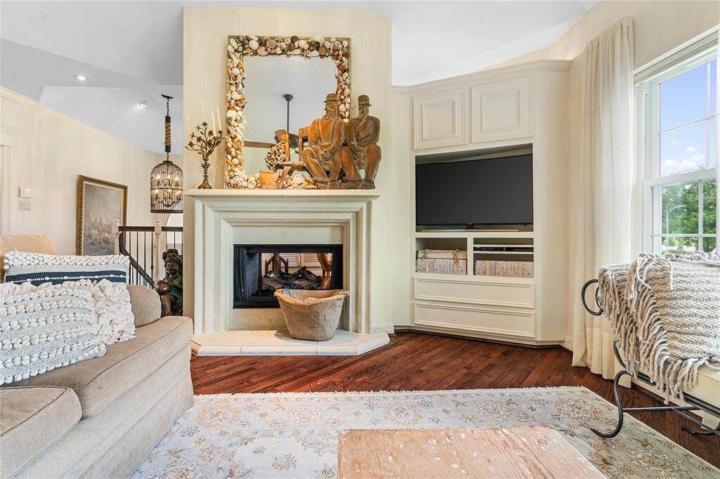 A CLOSER LOOK AT THE DOUBLE-SIDED FIREPLACE AND THE CUSTOM BUILT-INS OFFER STORAGE AND MEDIA SPACE.