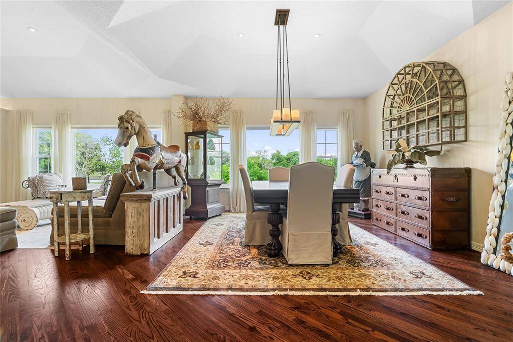THE DINING AREA FEATURES OVERSIZED WINDOWS WITH GORGEOUS GREEN VIEWS.