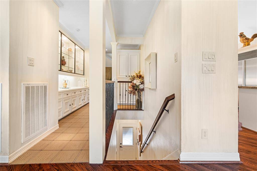 A SECONDARY STAIRCASE LEADS FROM THE KITCHEN HALL TO THE LOWER LEVEL.