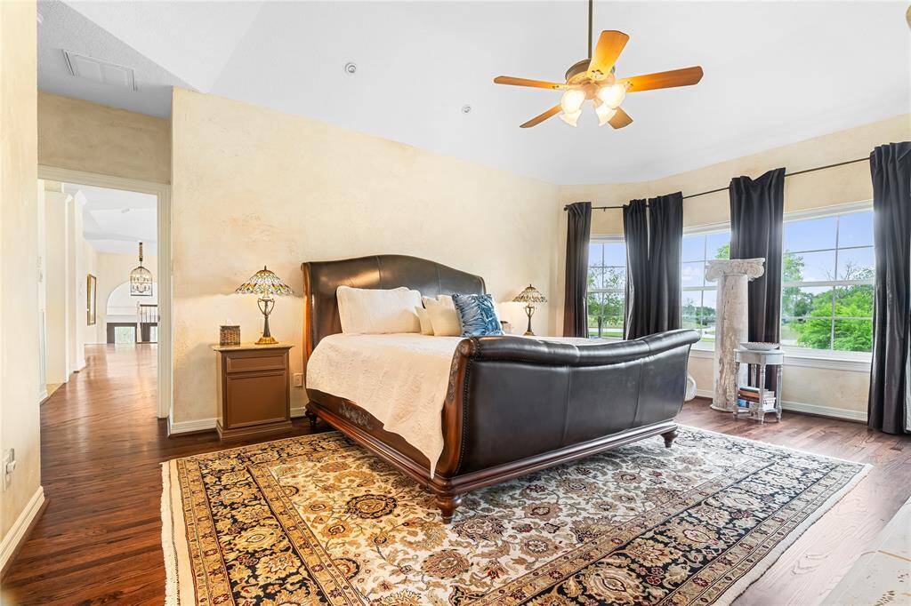 THIS PRIMARY SUITE BOASTS A VAULTED CEILING, BAY WINDOWS THAT FLOOD THE ROOM WITH NATURAL LIGHT.