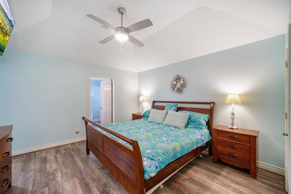 An alternate angle of the primary bedroom reveals a seamless transition into the en-suite bath.
