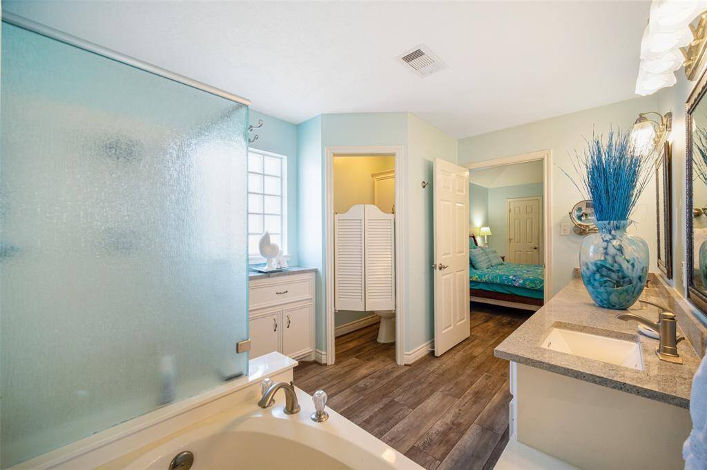 Indulge in the primary ensuite featuring a luxurious soaking tub and a spacious walk-in shower.