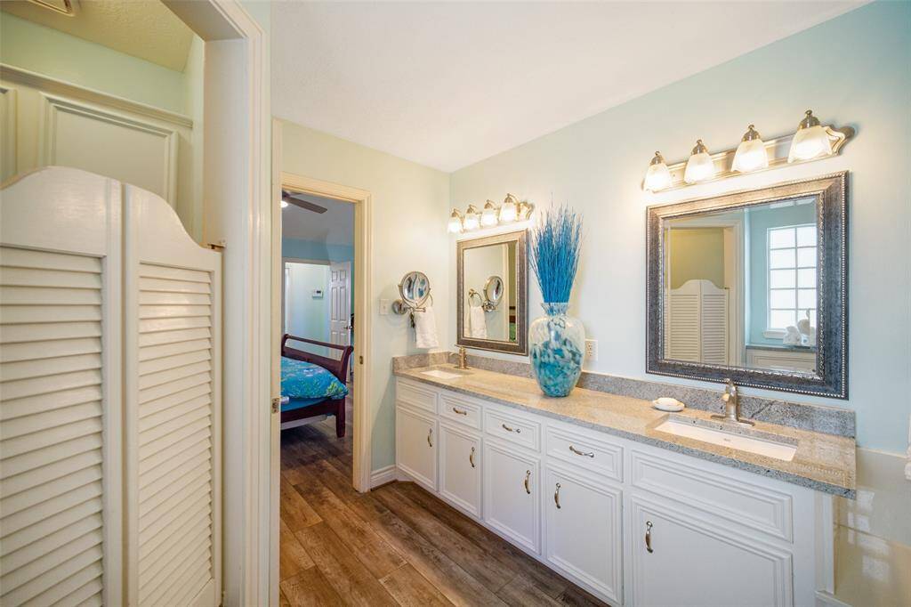 Luxurious primary bathroom with dual sinks, modern mirrors, and stylish lighting.