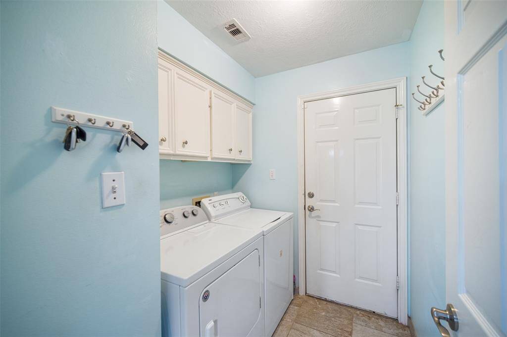 The utility room is located on the first floor offering cabinets for your laundry essentials.