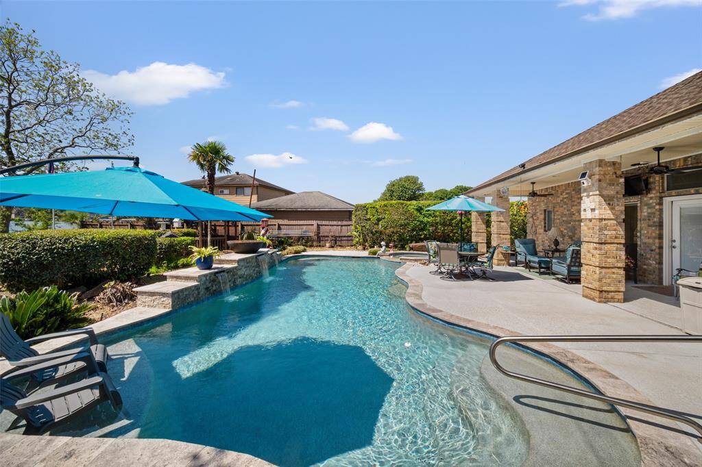 The sparkling pool, complete with tranquil waterfalls and a lounging station, make for ultimate relaxation and summertime fun.