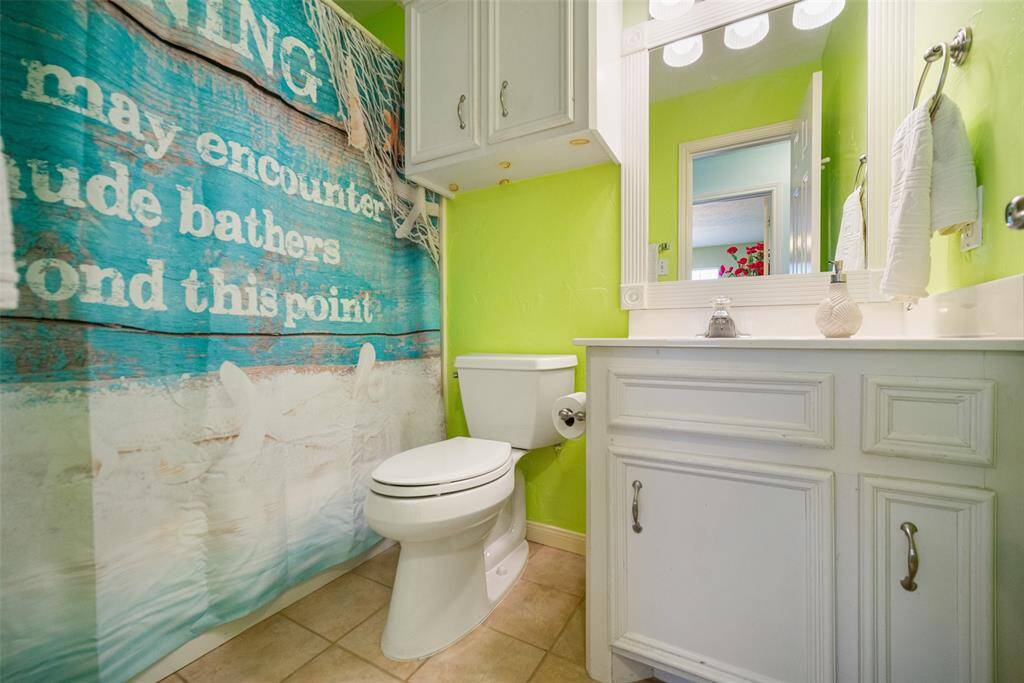 The upstairs secondary bathroom is convenient for both secondary bedrooms, offering a combo tub and shower, a sink, and cabinets to store your bathroom essentials.