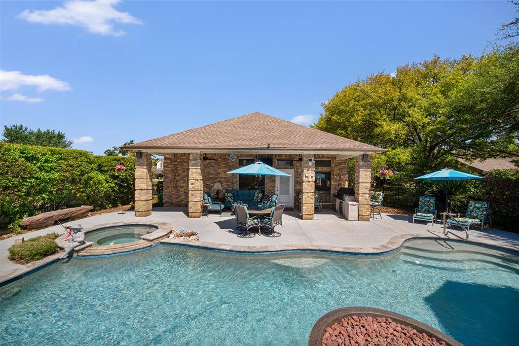 Your private backyard oasis boasts a covered patio, relaxing spa, and sparkling pool—perfect for year-round enjoyment and entertaining.