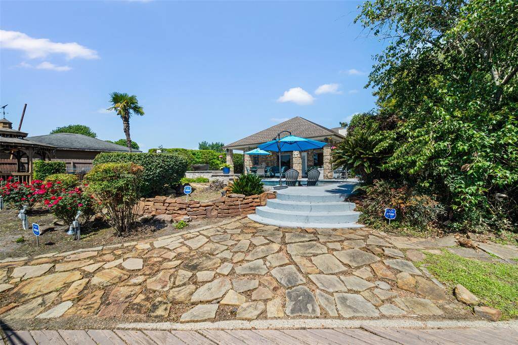 From the boat dock, you'll take in a beautiful alternate view back towards the pool, showcasing the seamless connection between outdoor living and lakeside relaxation.