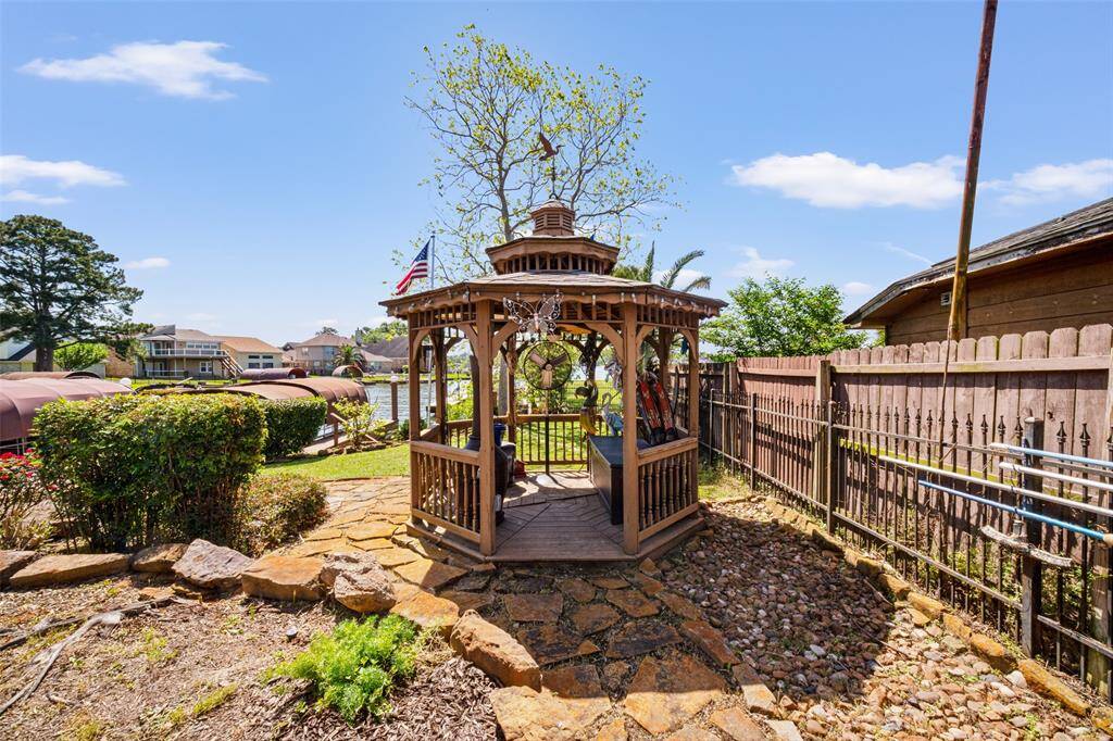 The lovely gazebo adds to the charm and beauty of the backyard, providing a perfect shaded retreat to relax.