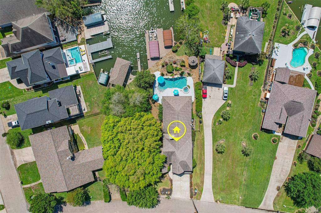 From above, you can take in the beautifully landscaped backyard, sparkling pool, and private boat dock.