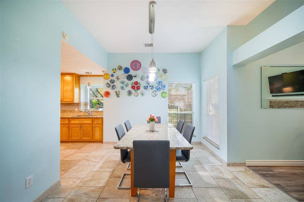 Discover the inviting breakfast room just off the entry, featuring a table that perfectly complements the kitchen countertops and is included with the home.