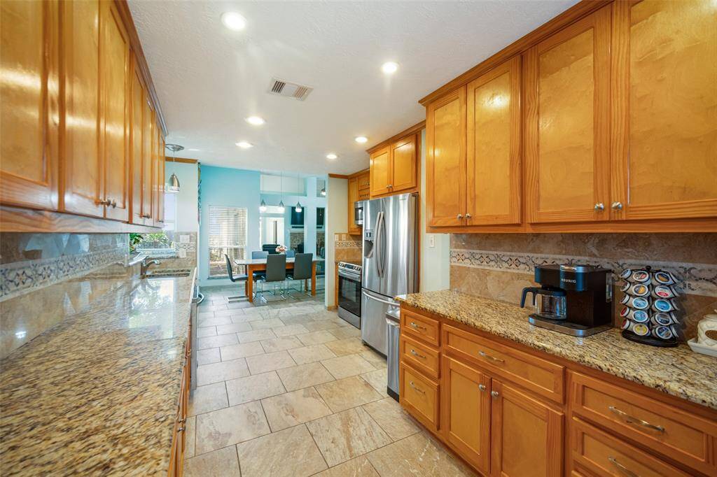 Designer inspired finished include tile flooring, a stylish backsplash, drawer and knob pulls on the cabinets and drawers, decorative crown molding above the cabinetry, and recessed lighting.