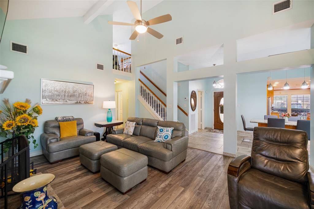 The den is situated near the entry of the home and the breakfast room, creating an inviting, open-concept space for easy flow and interaction.