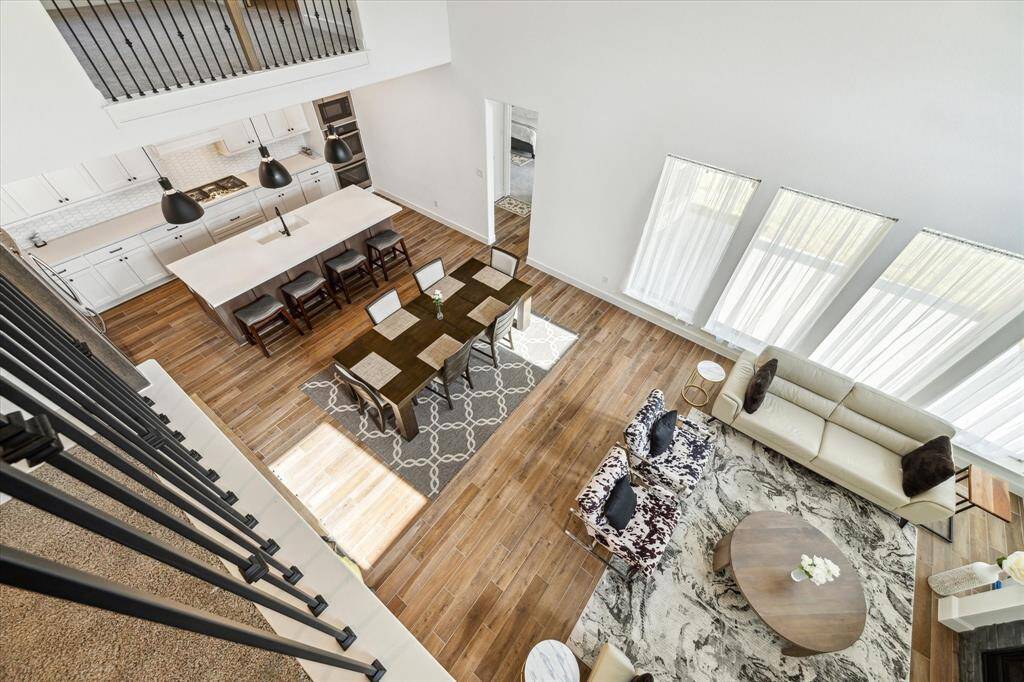 Another view of the bright andspacious living room, dining area, and kitchen.